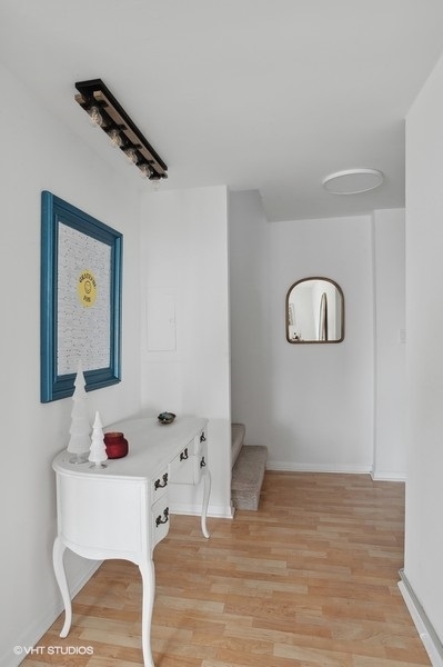 1221 North Dearborn Parkway, Unit PH10N Chicago, IL 60610 - Photo 11 of 23 a white bath tub sitting next to a white sink and vanity
