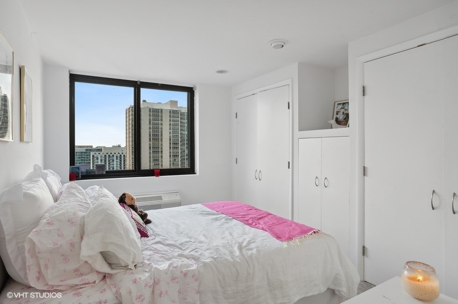 1221 North Dearborn Parkway, Unit PH10N Chicago, IL 60610 - Photo 13 of 23 a bedroom with a bed and a window