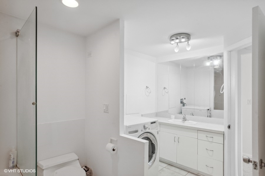 1221 North Dearborn Parkway, Unit PH10N Chicago, IL 60610 - Photo 16 of 23 a bathroom with a sink a toilet and shower