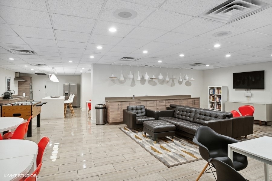 1221 North Dearborn Parkway, Unit PH10N Chicago, IL 60610 - Photo 20 of 23 a living room with lots of furniture and a flat screen tv