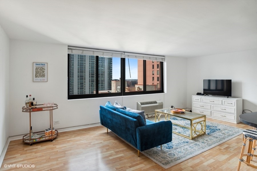 1221 North Dearborn Parkway, Unit PH10N Chicago, IL 60610 - Photo 3 of 23 a living room with furniture and a flat screen tv