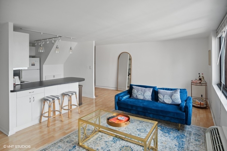 1221 North Dearborn Parkway, Unit PH10N Chicago, IL 60610 - Photo 5 of 23 a living room with furniture and wooden floor