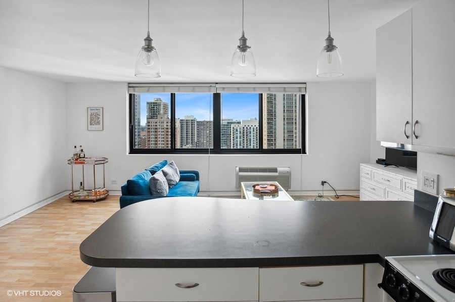 1221 North Dearborn Parkway, Unit PH10N Chicago, IL 60610 - Photo 7 of 23 a living room with table chairs and a window