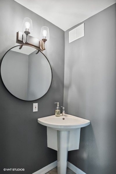 1221 North Dearborn Parkway, Unit PH10N Chicago, IL 60610 - Photo 10 of 23 a bathroom with a sink and a mirror