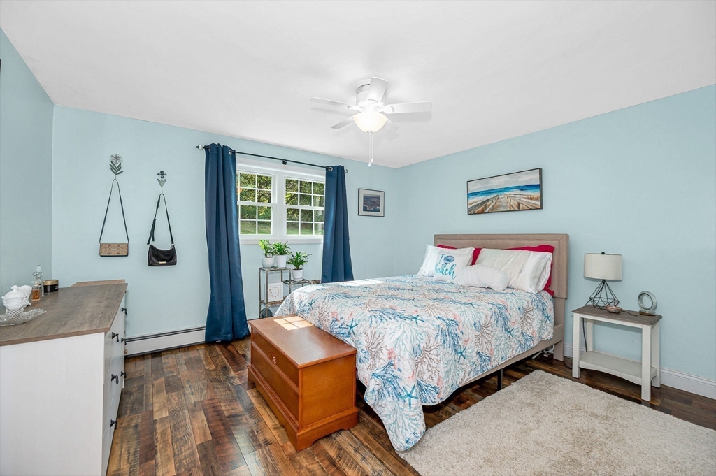 1 Brown Avenue, Unit 380 Amesbury, MA 01913 - Photo 13 of 25 a bedroom with a large bed and a chandelier