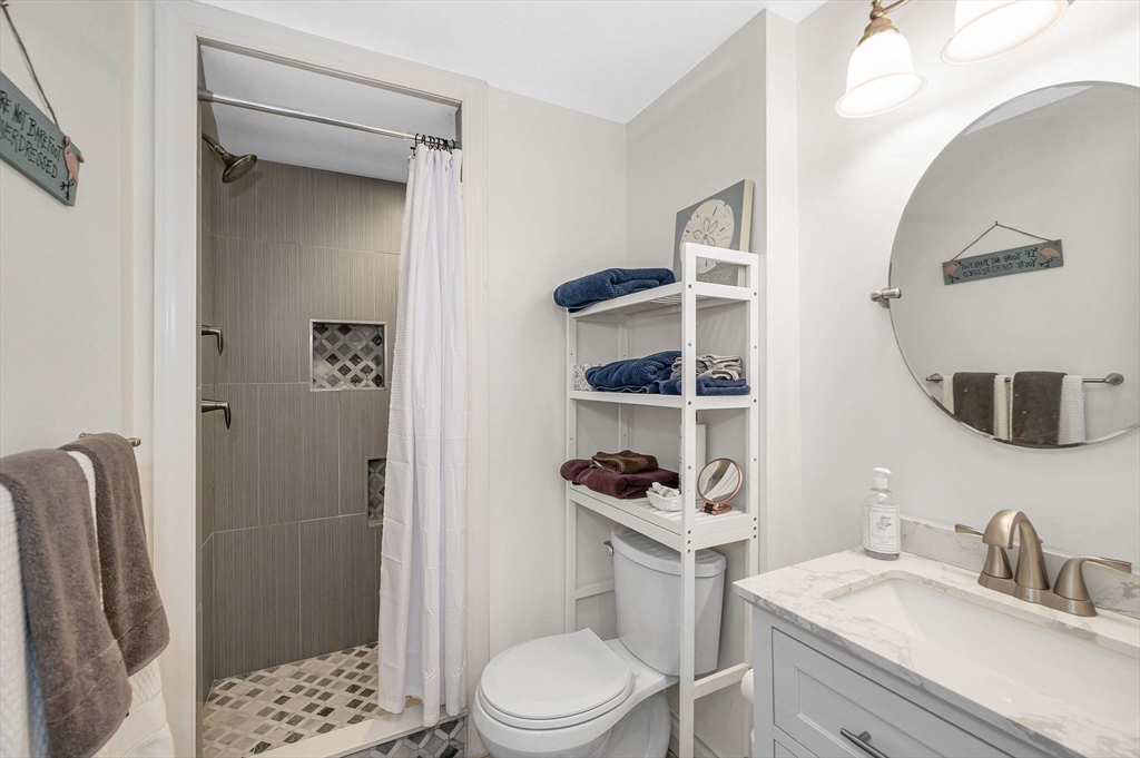 1 Brown Avenue, Unit 380 Amesbury, MA 01913 - Photo 17 of 25 a bathroom with a sink a toilet and shower