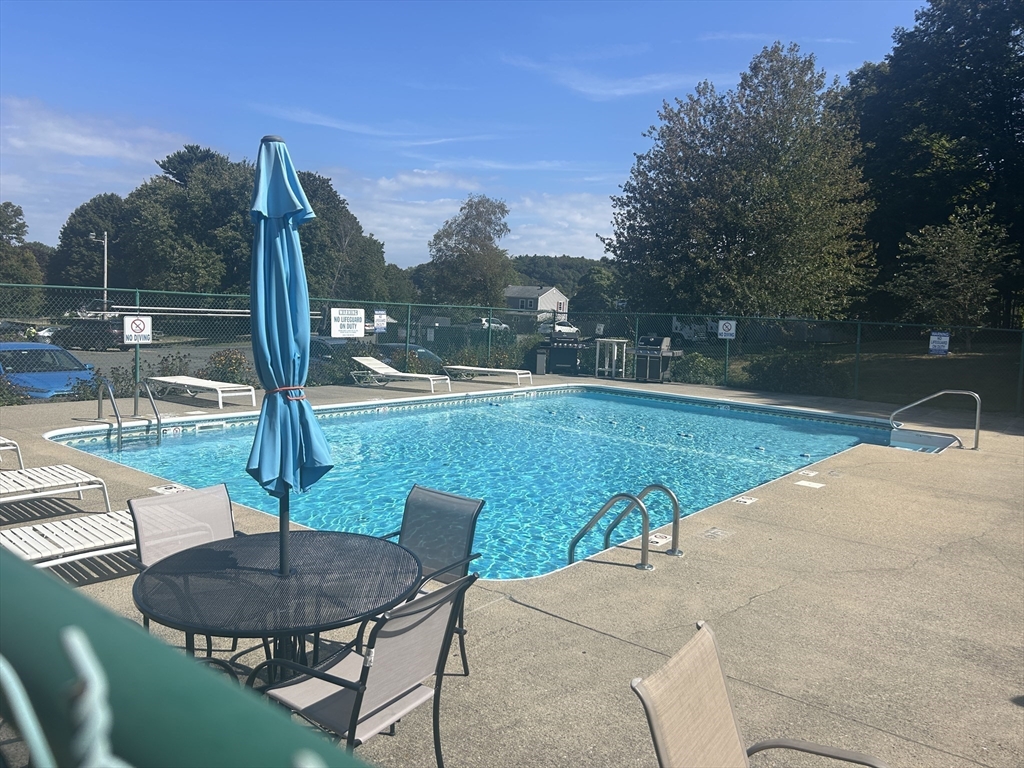 1 Brown Avenue, Unit 380 Amesbury, MA 01913 - Photo 24 of 25 a view of a swimming pool with a patio and a yard