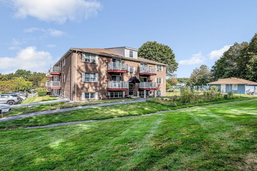 1 Brown Avenue, Unit 380 Amesbury, MA 01913 - Photo 3 of 25 a view of a big house with a big yard plants and large trees