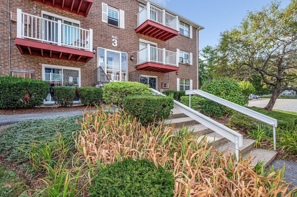 1 Brown Avenue, Unit 380 Amesbury, MA 01913 - Photo 4 of 25 a building view with a garden