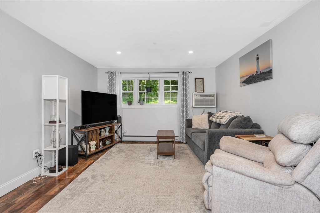 1 Brown Avenue, Unit 380 Amesbury, MA 01913 - Photo 9 of 25 a living room with furniture and a flat screen tv
