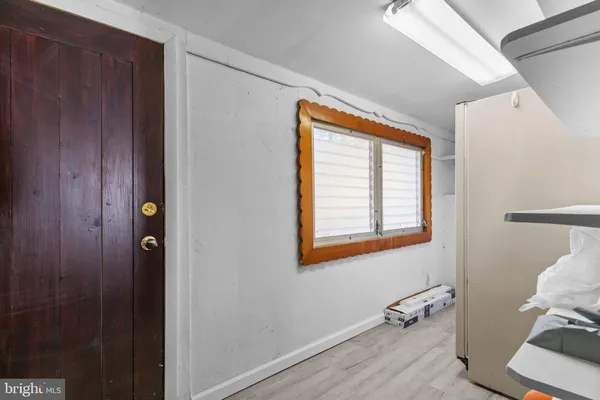 a view of an entryway with wooden floor and a window