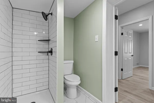 a bathroom with a toilet and a shower