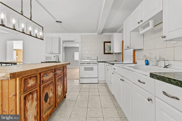 a kitchen with stainless steel appliances granite countertop a sink and cabinets