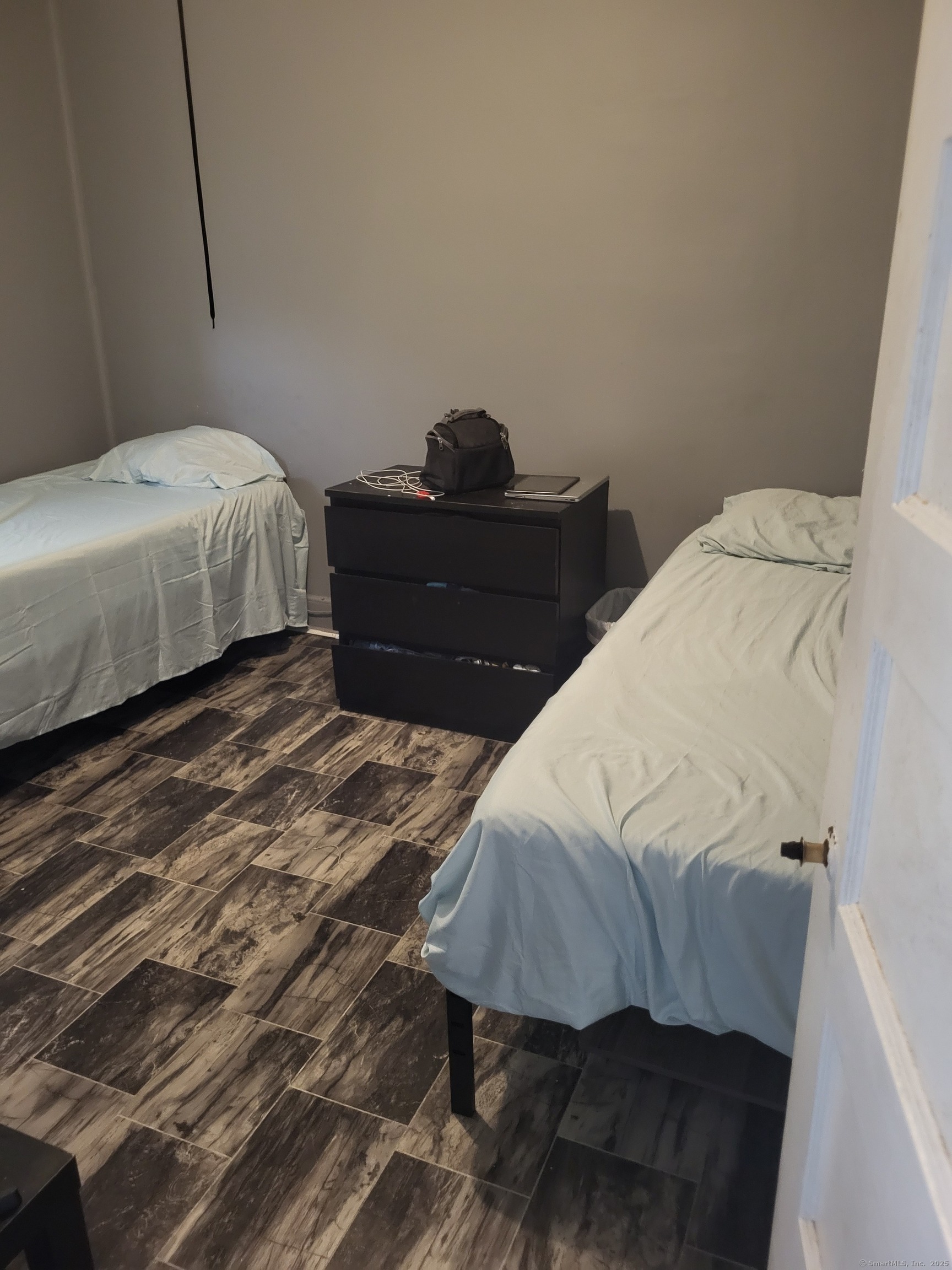 Undisclosed Address Bridgeport, CT 06607 - Photo 6 of 10 a bedroom with a bed and dresser