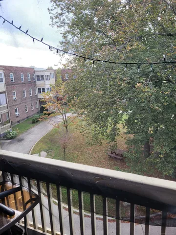 a view of a big house with a big yard and palm trees