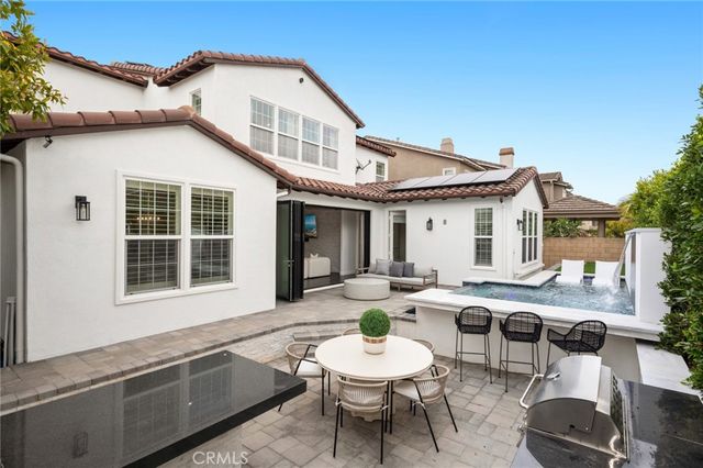 a view of a house with backyard sitting area and backyard