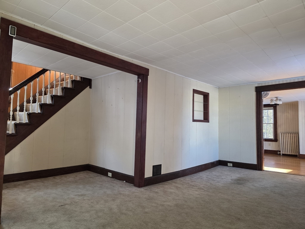 324 1/2 Chestnut Street Clinton, MA 01510 - Photo 13 of 21 a view of an empty room with stairs and a window