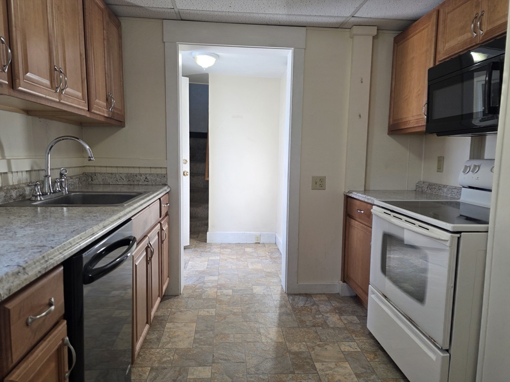 324 1/2 Chestnut Street Clinton, MA 01510 - Photo 6 of 21 a kitchen with stainless steel appliances granite countertop a sink stove and microwave