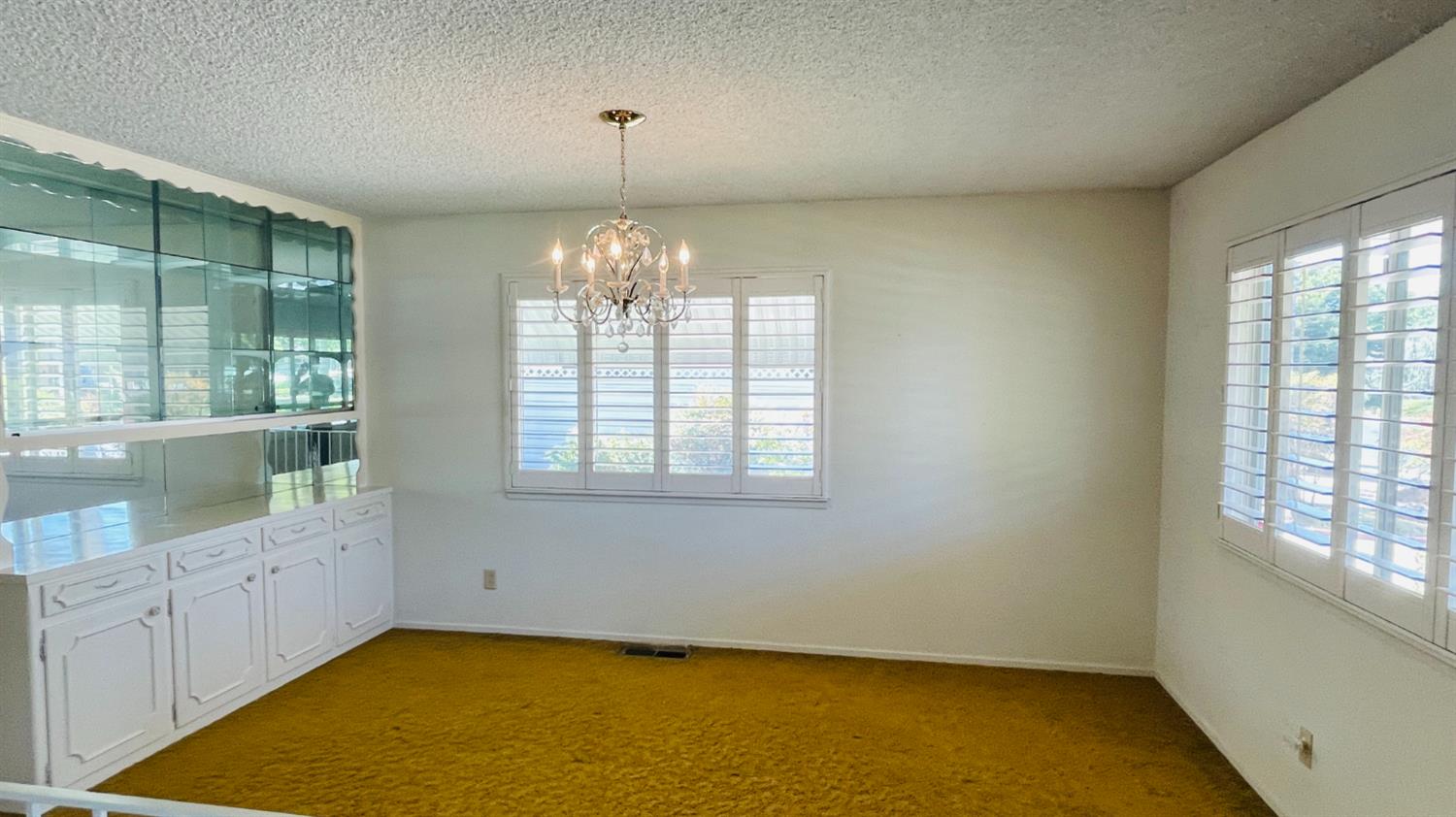 712 Leytonstone Avenue Modesto, CA 95355 - Photo 7 of 32 The formal dining room has a crystal chandelier and large built-in hutch.