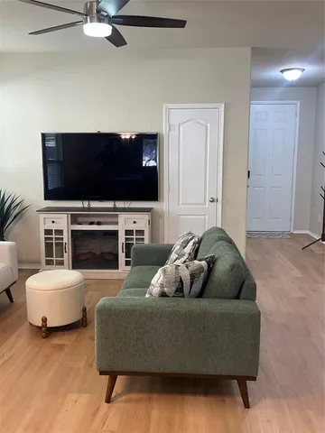 a living room with fireplace furniture and a flat screen tv