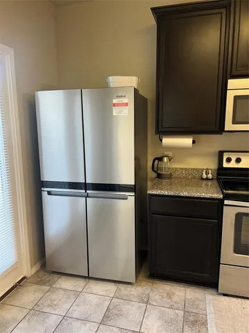 a refrigerator freezer sitting in a kitchen