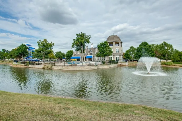 a view of a lake with houses in front of it