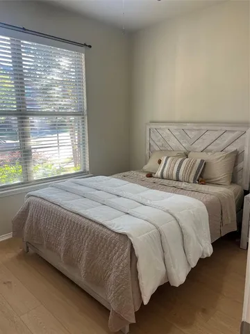 a bedroom with a bed and window