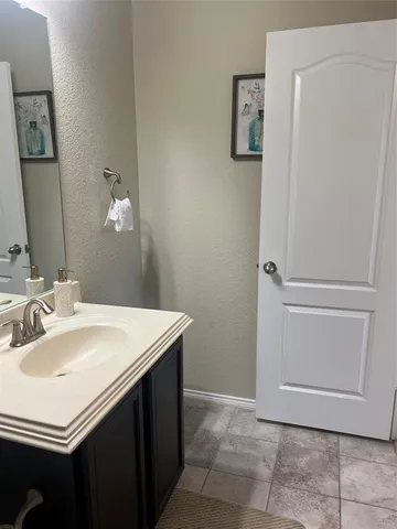 a bathroom with a sink vanity and a mirror