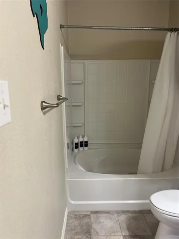a bathroom with a shower and a toilet