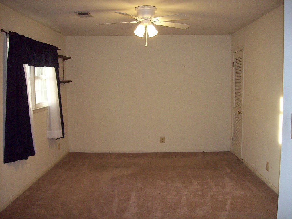 236 Chambers Road Macon, GA 31217 - Photo 9 of 29 an empty room with closet and a chandelier fan