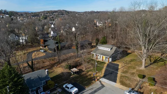 an aerial view of a house with a yard