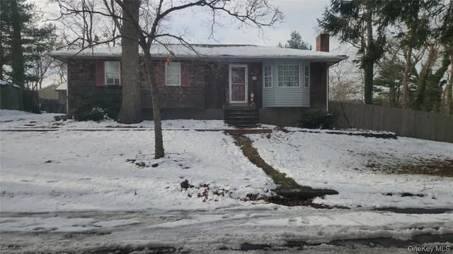 a view of a house with a yard covered with snow