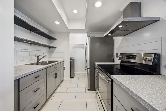 a kitchen with granite countertop a sink and cabinets
