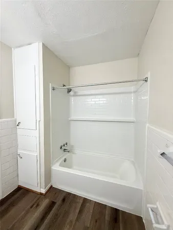 a bathroom with a bathtub and a shower