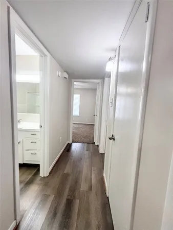 a view of a room with wooden floor