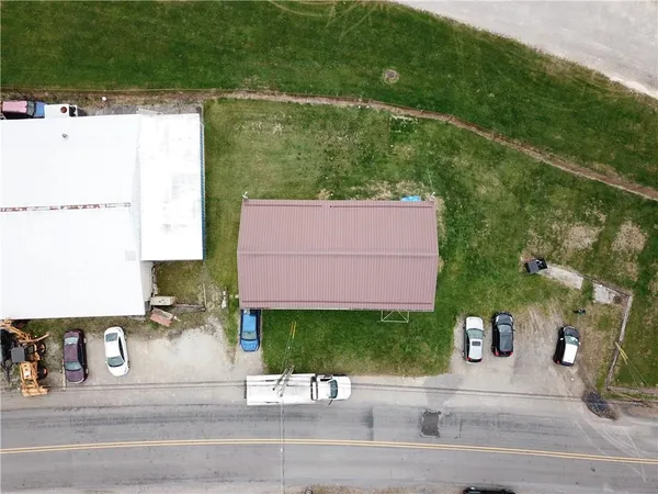 an aerial view of a house with a yard