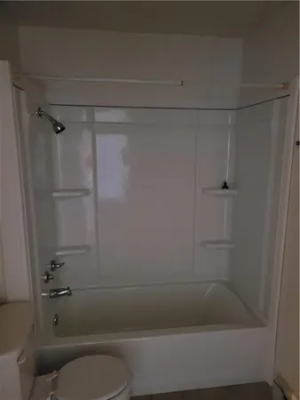 a bathroom with a shower and toilet