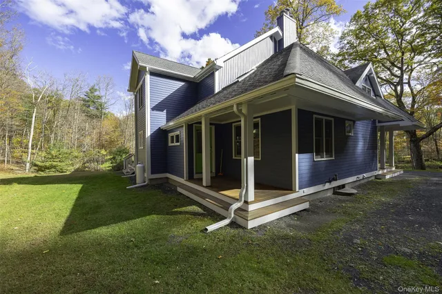 a view of a big room with a big yard and large tree