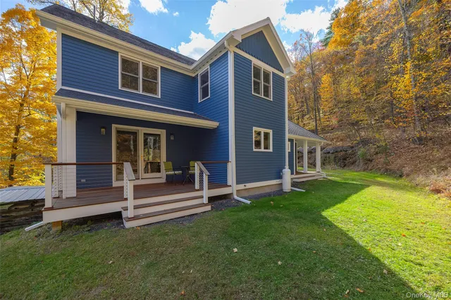 a view of a house with a yard and sitting area