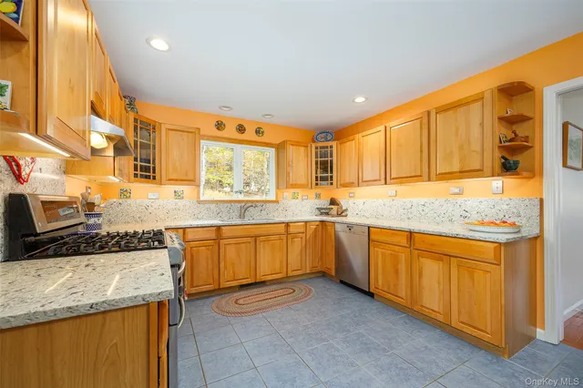 a kitchen with granite countertop sink and cabinets