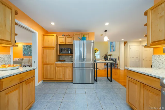 a kitchen with stainless steel appliances granite countertop a refrigerator and a sink