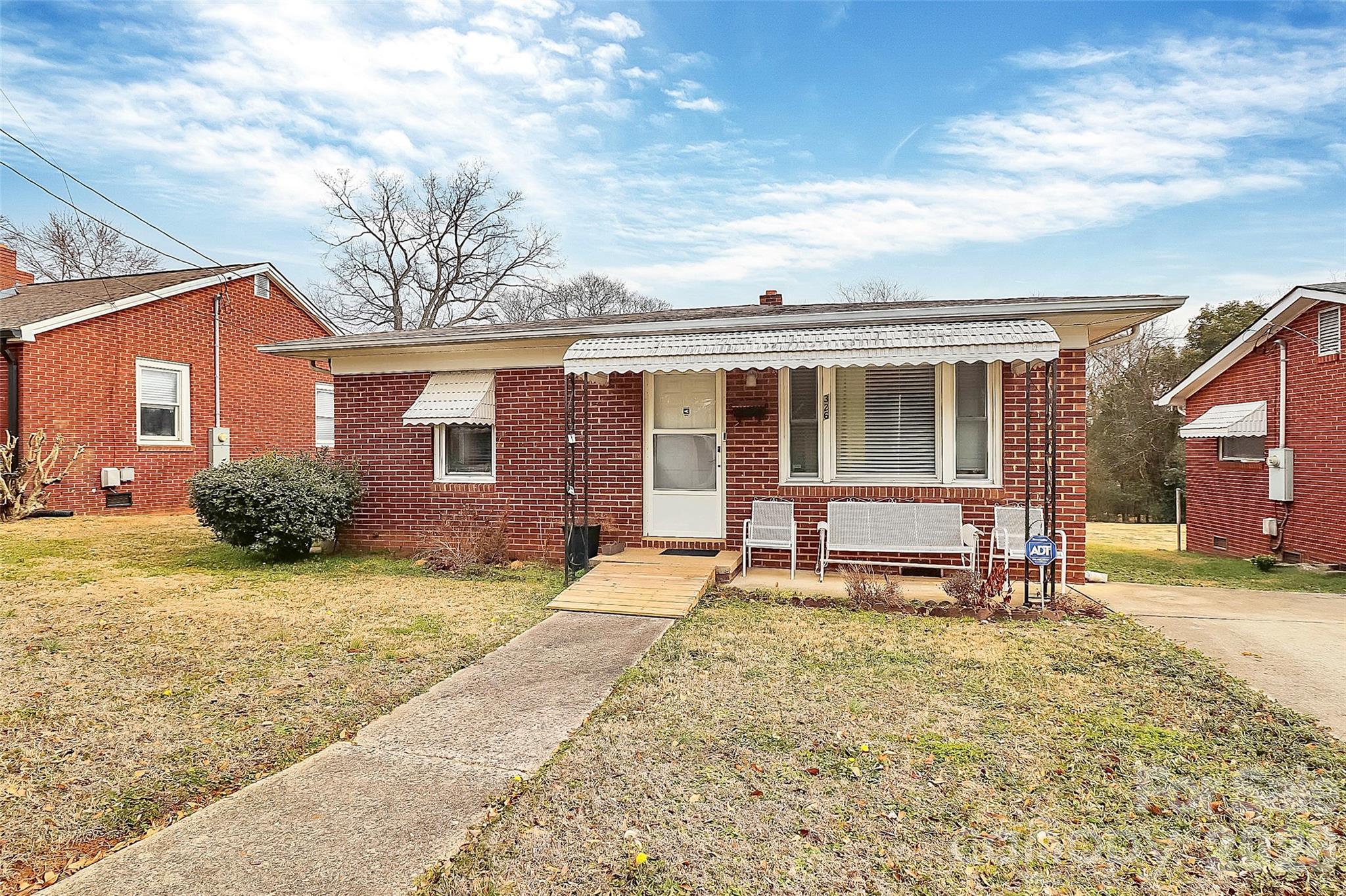 326 North Alexander Street Mount Holly, NC 28120 - Photo 2 of 11 a front view of a house with a garden and chairs