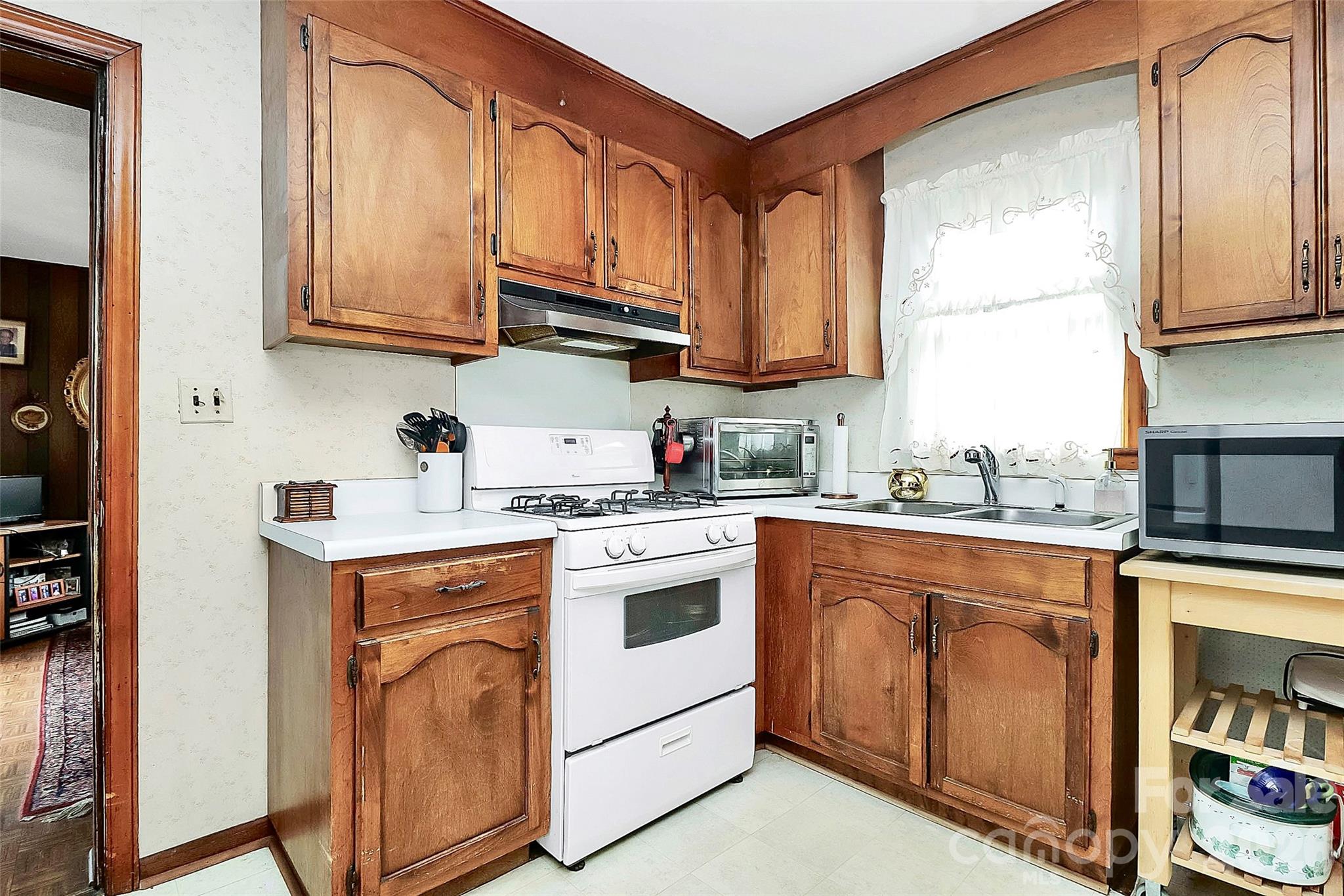 326 North Alexander Street Mount Holly, NC 28120 - Photo 4 of 11 a kitchen with stainless steel appliances granite countertop a stove and a microwave