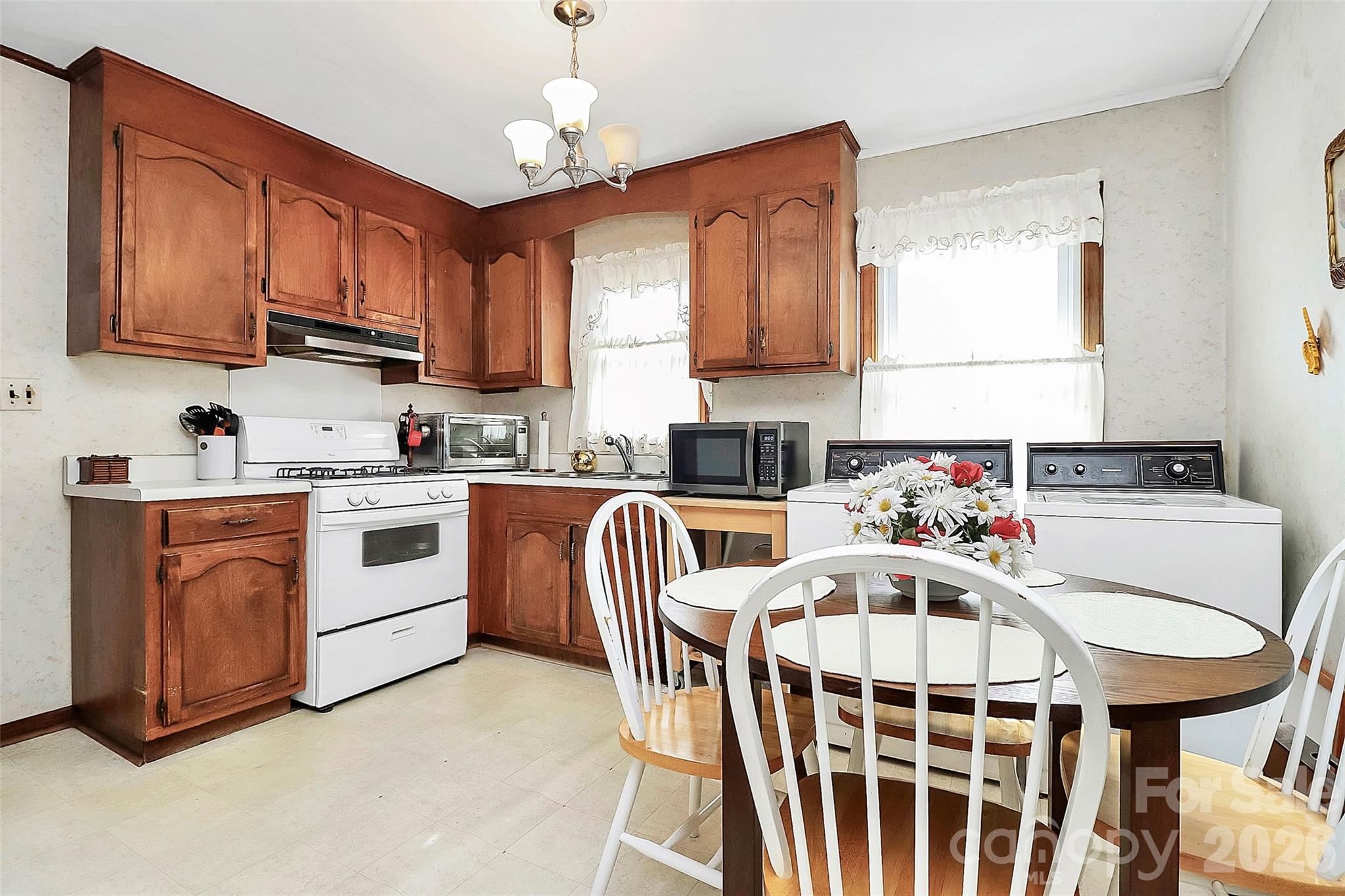 326 North Alexander Street Mount Holly, NC 28120 - Photo 5 of 11 a kitchen that has a cabinets stainless steel appliances and a dining table