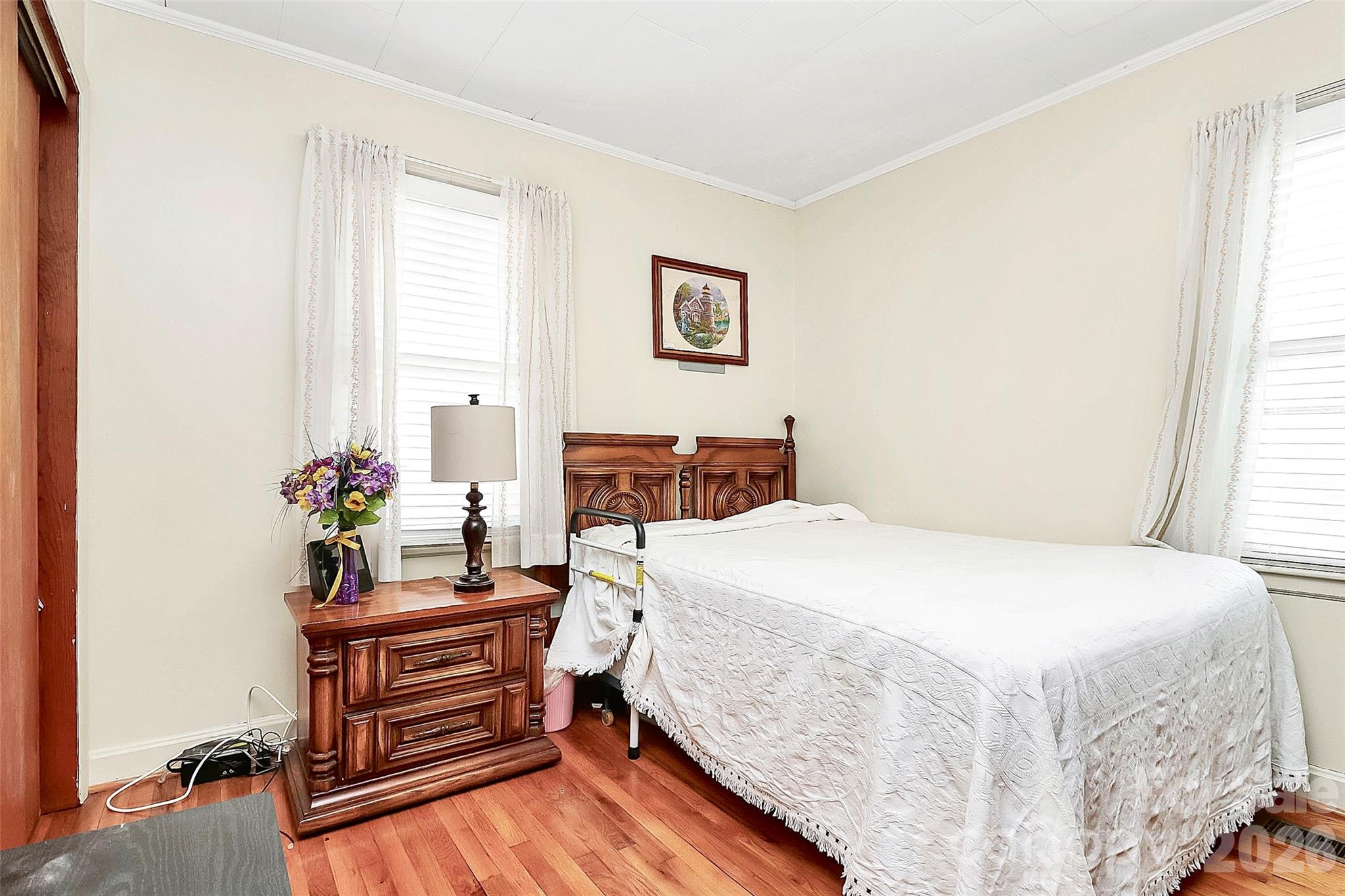 326 North Alexander Street Mount Holly, NC 28120 - Photo 6 of 11 a bedroom with a bed table and a window