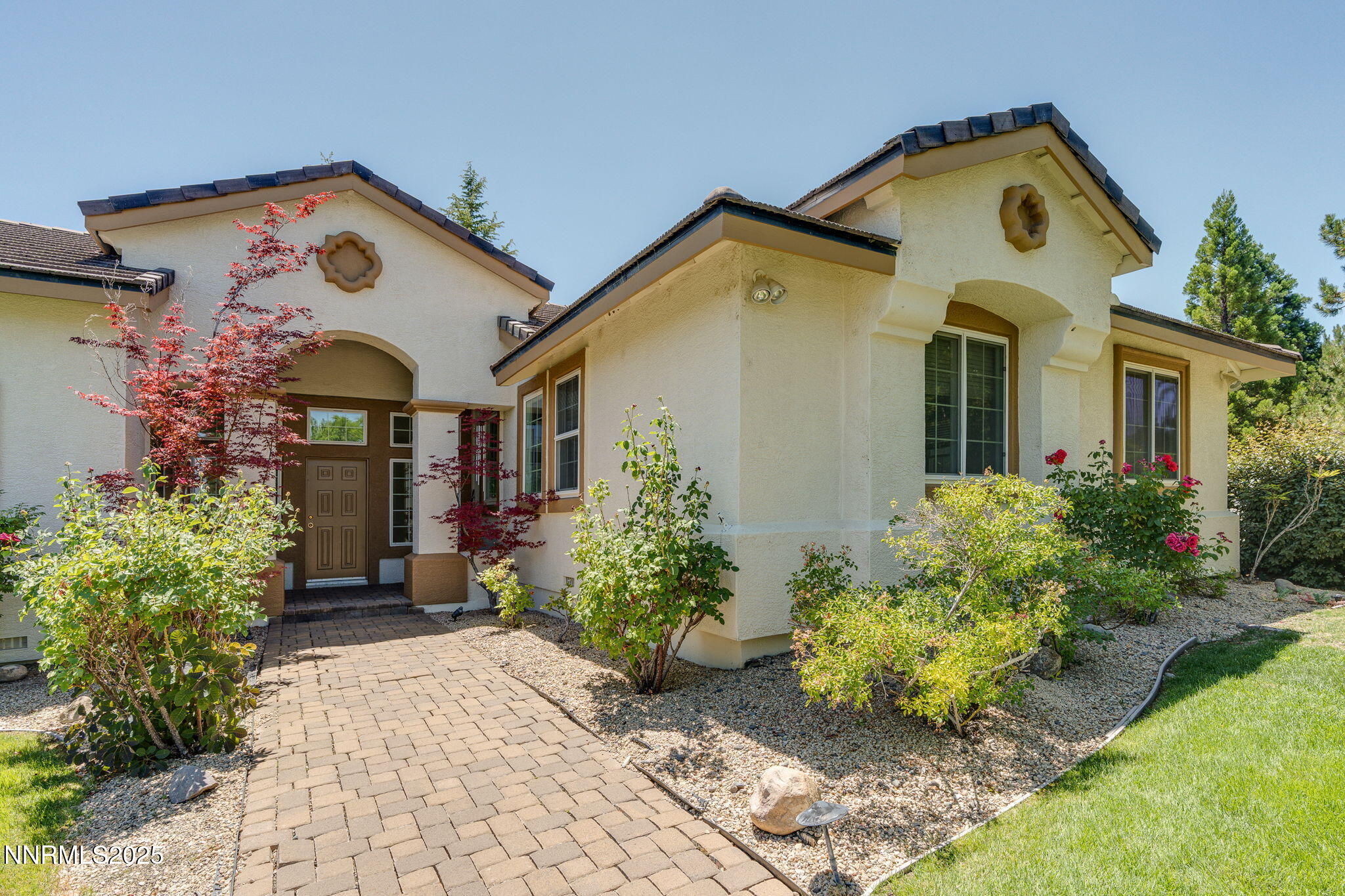 a front view of a house with garden