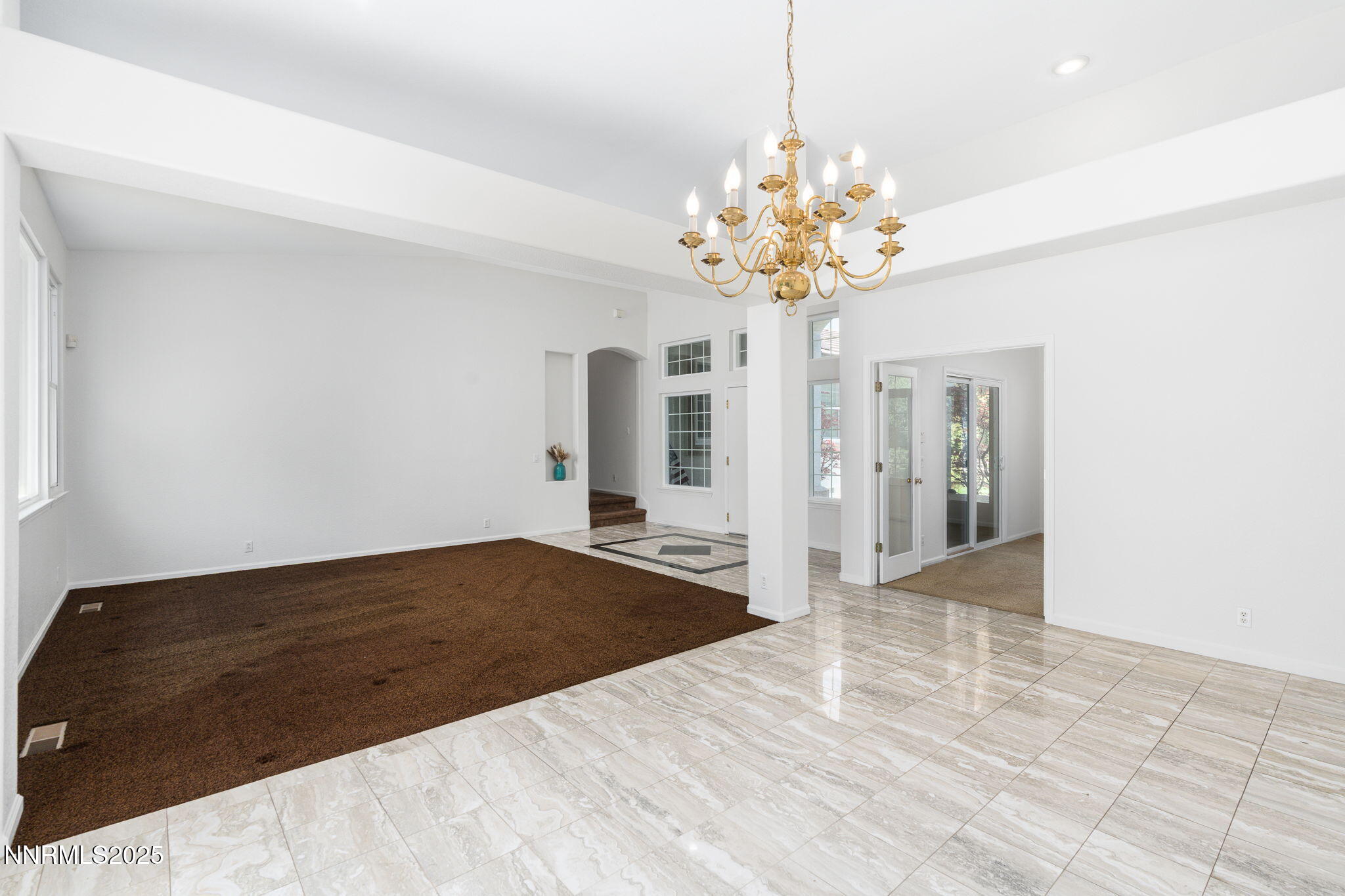 1300 Flanders Road Reno, NV 89511 - Photo 12 of 46 a view of a bedroom with a chandelier