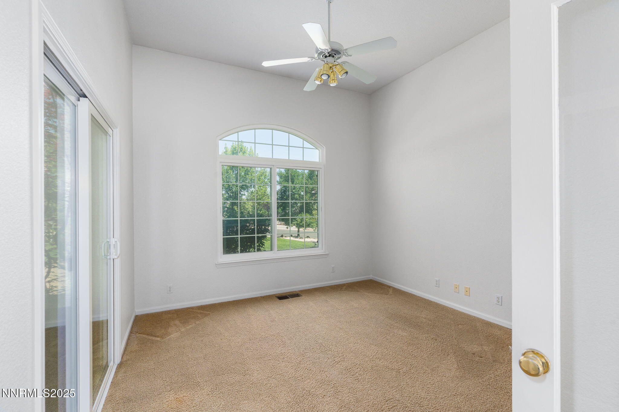 1300 Flanders Road Reno, NV 89511 - Photo 13 of 46 an empty room with a window and a fan