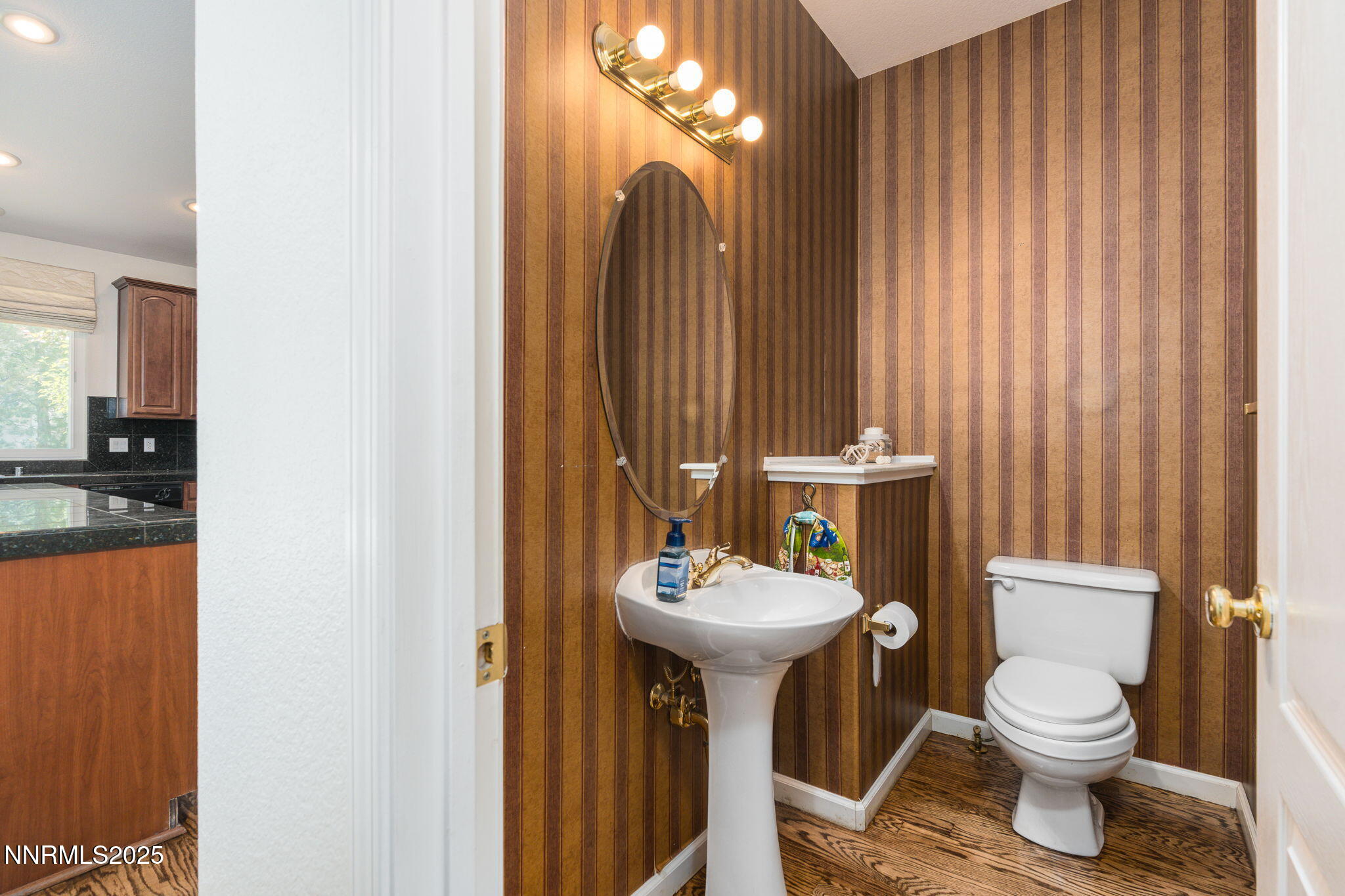 1300 Flanders Road Reno, NV 89511 - Photo 18 of 46 a bathroom with a toilet a sink and mirror