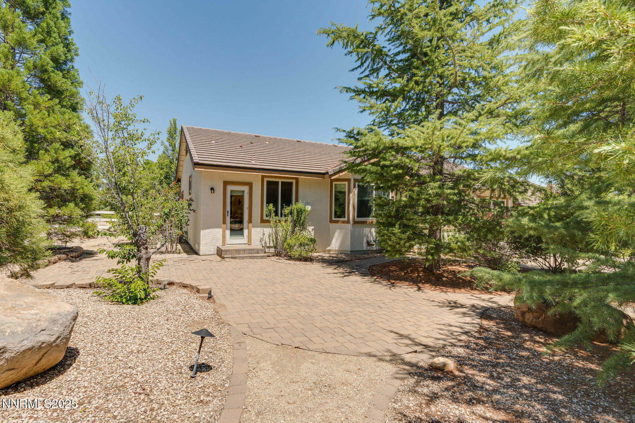 1300 Flanders Road Reno, NV 89511 - Photo 34 of 46 a front view of a house with a yard and potted plants